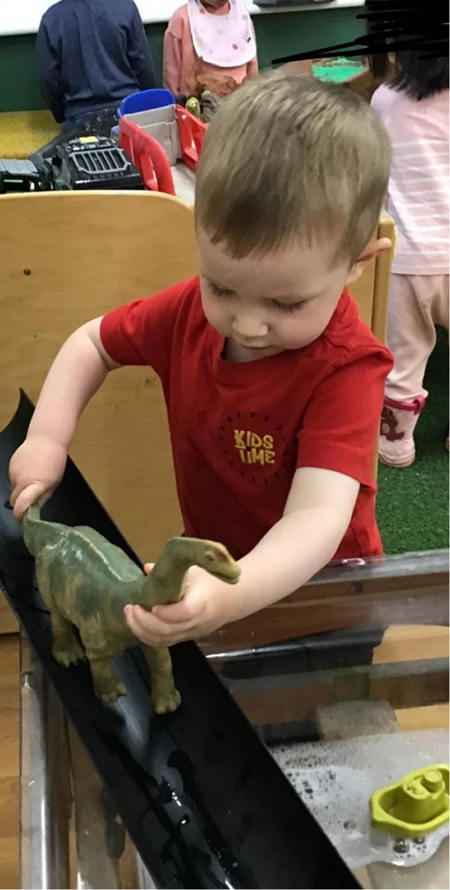 kids in uniforms playing with animals